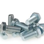 Shiny galvanized metallic bolts in various sizes, showcasing industrial hardware precision and functionality.