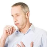 Middle-aged man coughing in a light-colored shirt, reflecting respiratory issues due to cold air exposure.