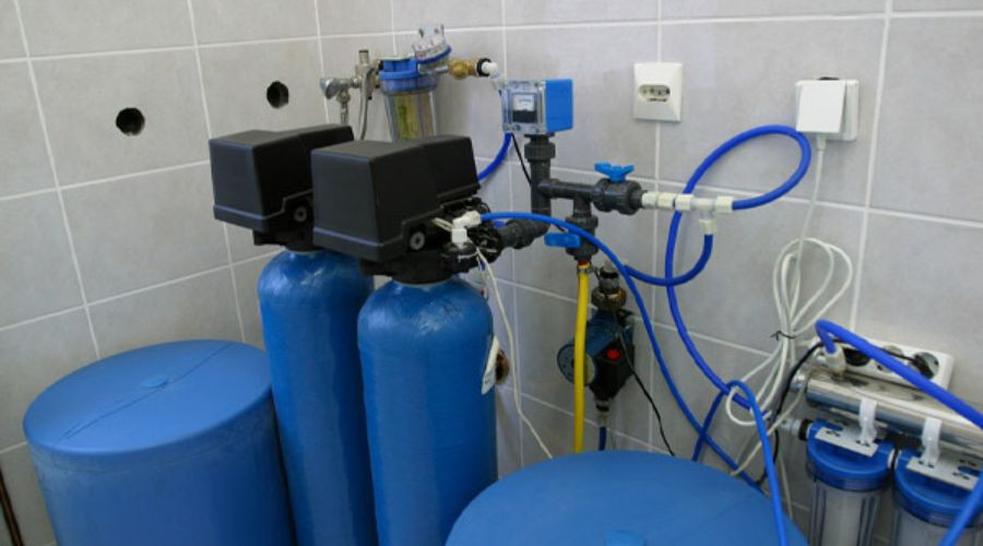 Water treatment equipment with pressure gauges and valves at RupCoe Plumbing, Heating & Air Conditioning facility.