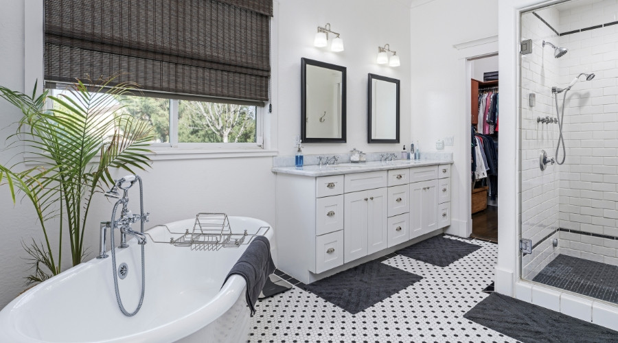 Modern bathroom interior featuring a freestanding bathtub, dual mirrors above a white vanity, and a walk-in shower, emphasizing stylish remodeling ideas for homeowners.
